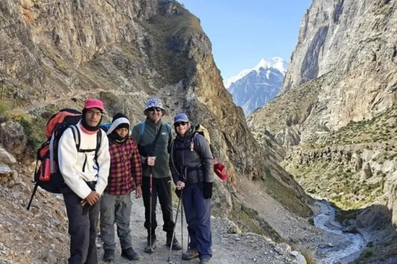 Group of trekkers fully equipped with proper hiking gear on a mountain trail featured in the Annapurna Circuit Trek Guide.