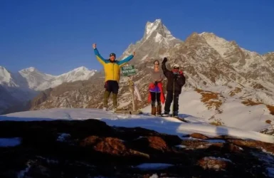Annapurna Circuit Trek Guide Successful Summit Trekkers celebrating a successful summit with snowy mountain peaks in the background featured in the Annapurna Circuit Trek Guide.