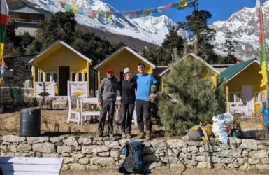 Annapurna Circuit Trek Guide Honeymoon Treks Couple enjoying a romantic mountain getaway in front of colorful alpine lodges featured in the Annapurna Circuit Trek Guide.